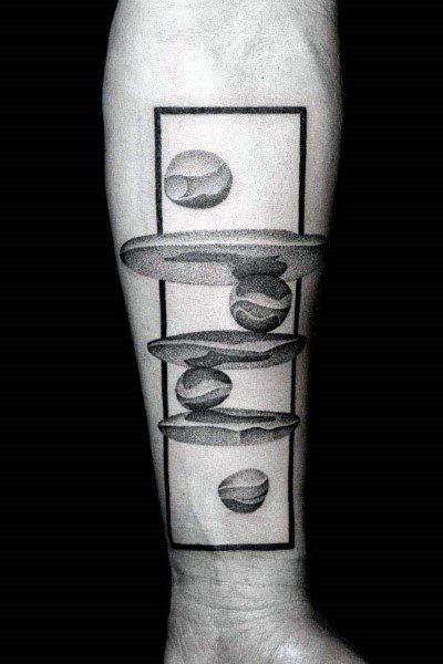 Black and gray marble tattoo on the forearm, featuring floating marbles with geometric shapes and shading for a surreal 3D effect.