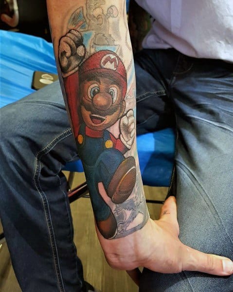 Realistic Mario tattoo on a man's forearm, featuring detailed shading, vibrant colors, and dynamic motion as he jumps with a power-up.
