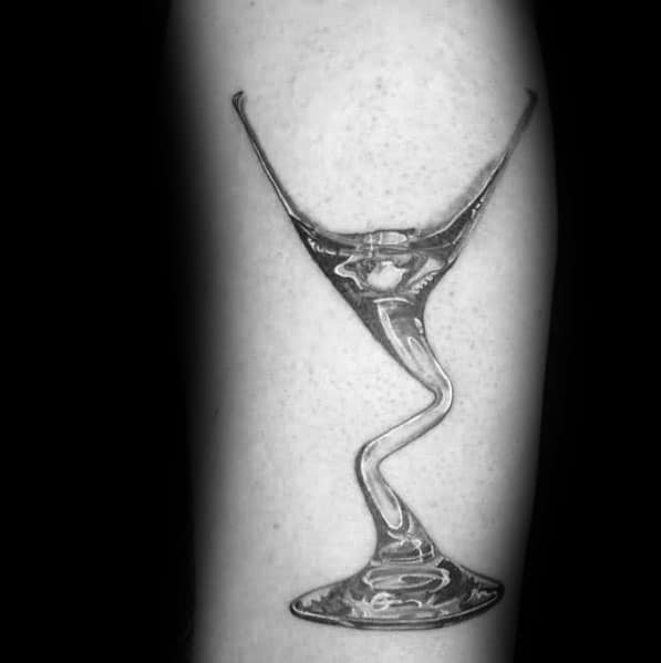 Black and grey martini glass tattoo with a surreal, melting stem design. A sleek and artistic concept creating a fluid, distorted effect.