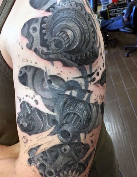 Arm tattoo featuring mechanical gears inked in black and gray