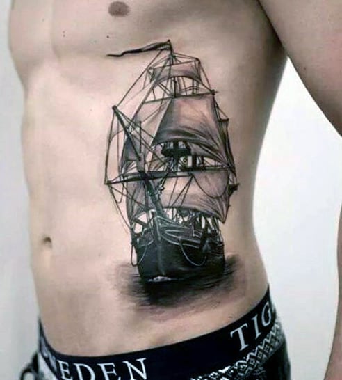 Tattoo of a detailed sailing ship on a person's side, depicting sails and hull with intricate shading