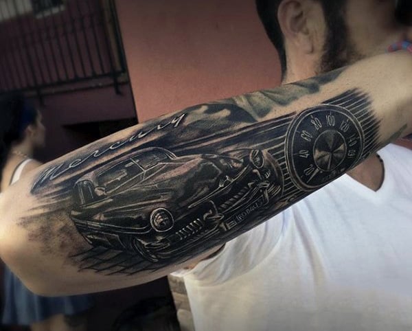 Forearm tattoo of a classic car and speedometer with the word "Mercury" in script lettering above the design