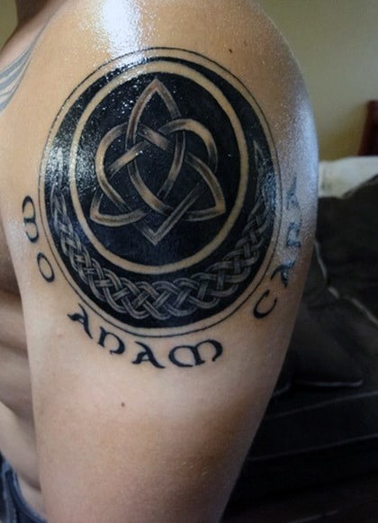 Shoulder tattoo featuring a Celtic knot with the words "mo anam cara" underneath