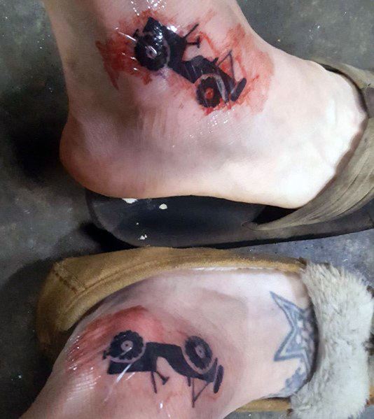 Matching Jeep tattoos on the ankles, featuring a minimalist off-road Jeep design flipped upside down with a red, scraped effect for a rugged look.