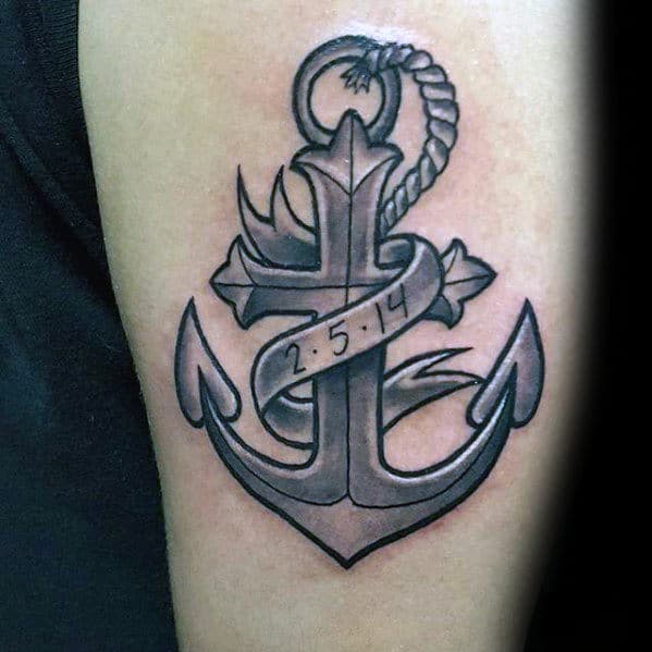Anchor tattoo with a date ribbon, showing "2.5.14", inked on a person's arm