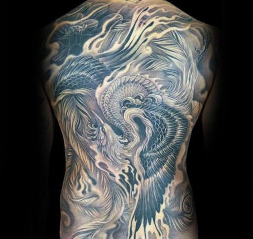 Intricate full-back tattoo of a phoenix with detailed feathers and flames