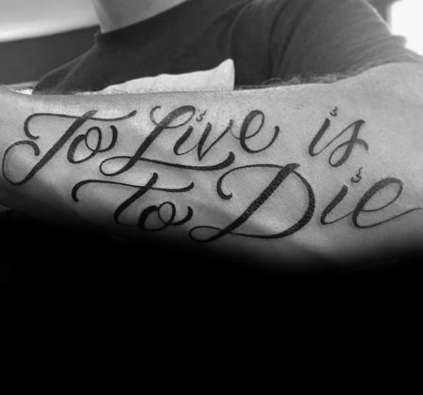 Elegant script tattoo on forearm reading To Live is to Die, inspired by Metallica’s instrumental tribute song.