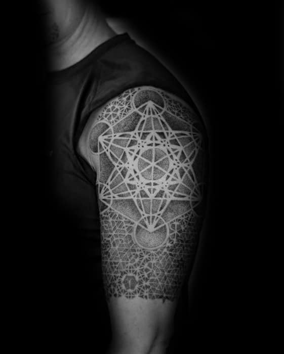Upper arm tattoo of Metatron’s Cube with bold white ink lines over intricate dotwork geometry, creating a luminous and layered design.