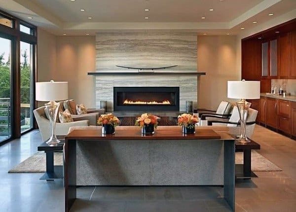 Elegant living room with modern fireplace, marble accent wall, and symmetrical decor.