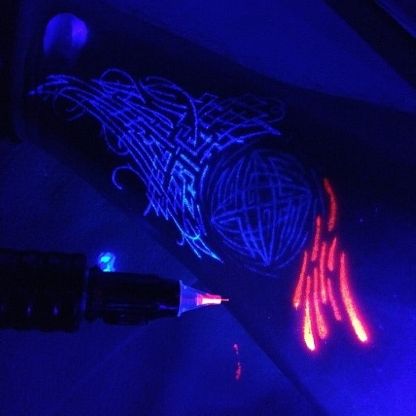 Cool Orange And Blue Glow In The Dark Black Light Tattoos On Man