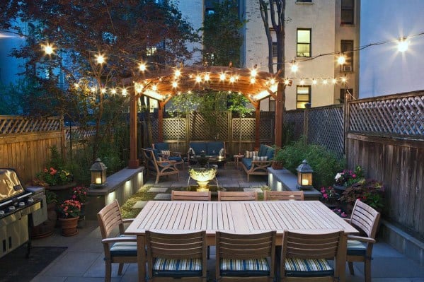 backyard patio string lights wood table
