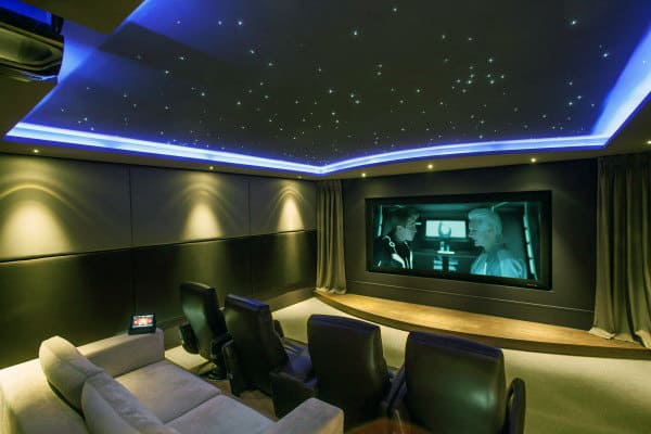 Home theater with star ceiling, a large screen movie, and cozy leather recliners