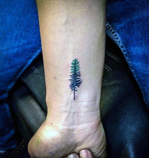 Cool Quarter Sized Black And Green Ink Pine Tree Wrist Tattoo Design Ideas For Male