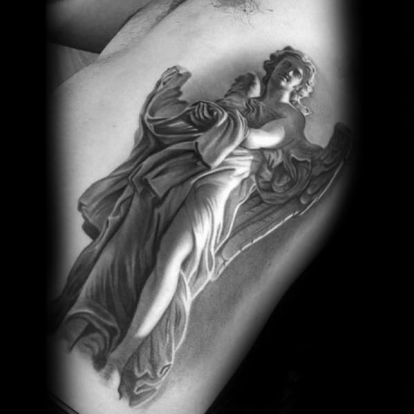 A detailed black and grey tattoo on the side of the torso depicting an angel in motion, with flowing robes and large wings.
