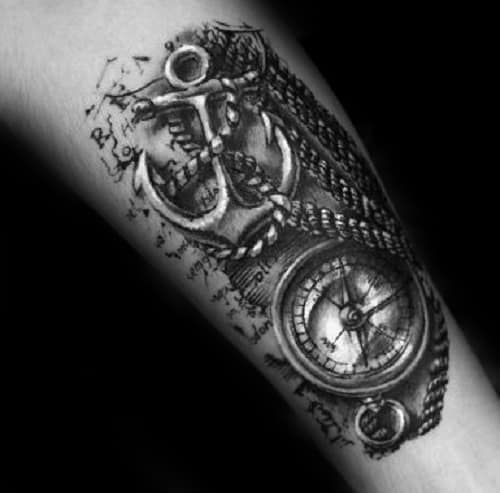 Forearm tattoo of an anchor intertwined with a compass and rope