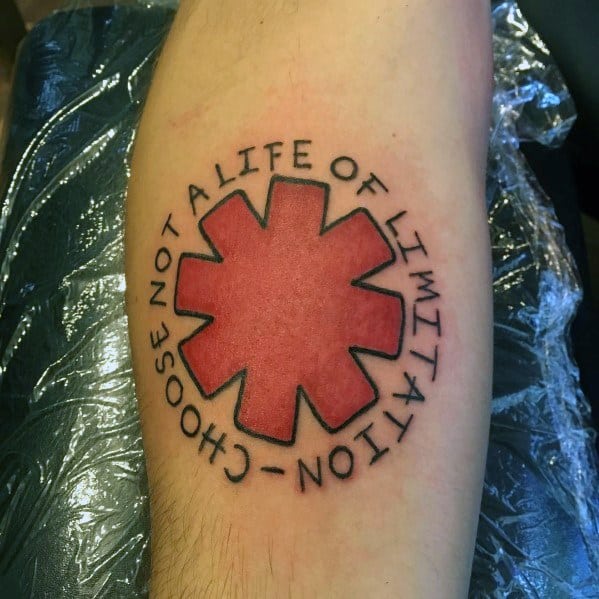 Tattoo featuring the Red Hot Chili Peppers logo with the phrase "Choose not a life of limitation" encircling it, creating a bold tribute design.