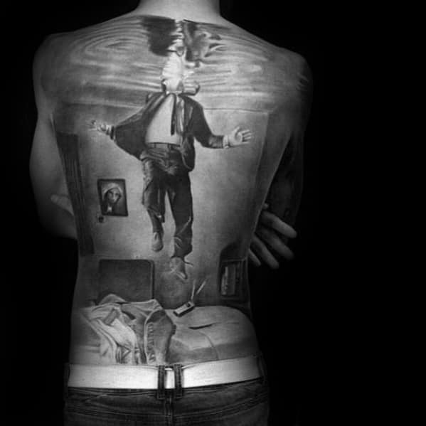 Hyper-realistic full-back tattoo of a man floating towards a water surface, creating a surreal reflection effect with incredible depth.