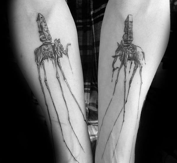 Matching Salvador Dali-style tattoos of elephants with elongated legs and obelisks, inked in fine black linework on both forearms.