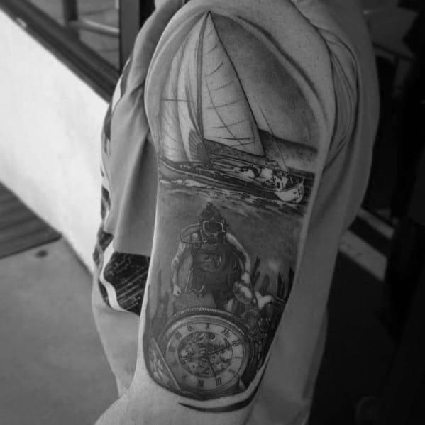 Detailed black and grey tattoo sleeve featuring a scuba diver underwater, a pocket watch, and a sailboat above the surface.