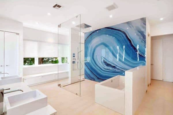 Modern bathroom with sleek shower, white fixtures, and a striking blue agate accent wall