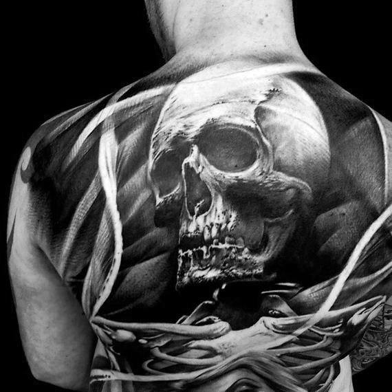Bold skull back tattoo with intense contrast, surrounded by swirling white ribbons and dark shadows for a dramatic, 3D effect.