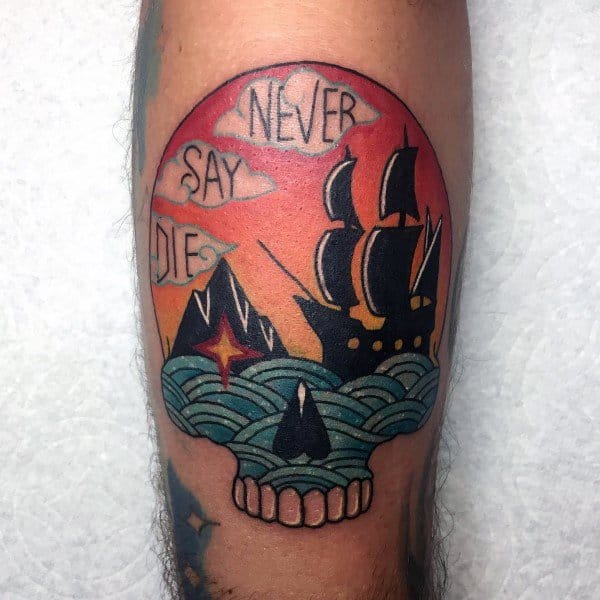 Colorful traditional-style tattoo inspired by The Goonies, featuring a skull, pirate ship, ocean waves, and the phrase "Never Say Die" in clouds.
