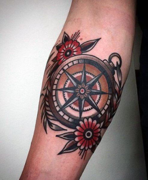 Classic compass tattoo with bold black outlines, red floral details, and fine shading, creating a timeless and masculine design.