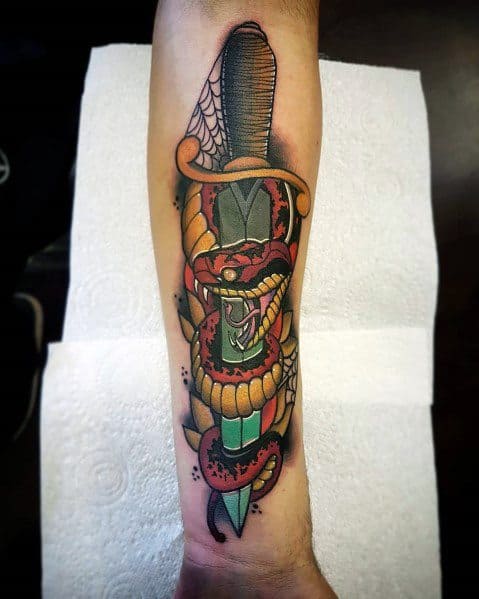 Vibrant snake and dagger tattoo on forearm, featuring a red and black snake coiled around a green dagger with bold shading and details.