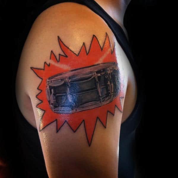 Cool Snare Drum Upper Arm Male Tattoo With Orange Ink Background