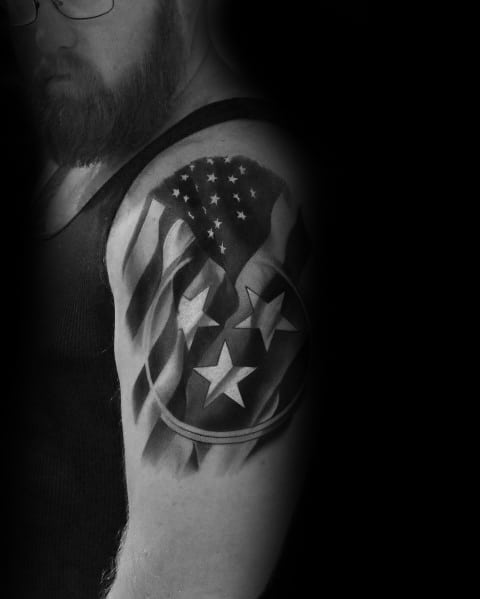 Black and grey Tennessee flag tattoo blended with the American flag, featuring the three-star emblem for a bold patriotic design.