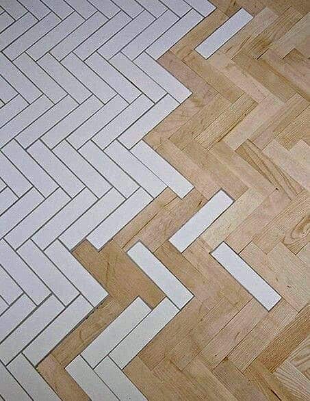 Creative herringbone tile-to-wood floor transition seamlessly merging white tiles with natural wood for a bold, unique pattern
