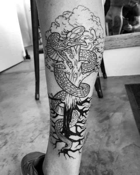 Black and grey tattoo of a tree entwined with a large serpent, featuring intricate roots and branches, symbolizing wisdom, transformation, and mythology.