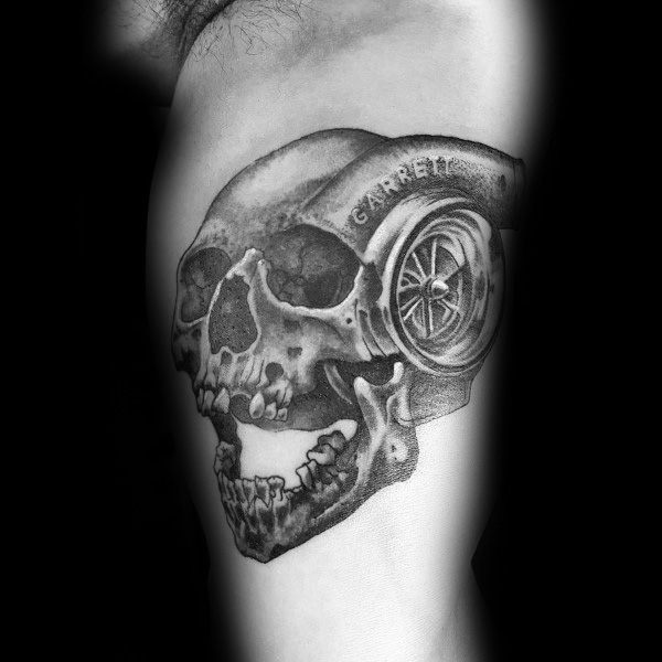Realistic skull and turbocharger tattoo on the upper arm with fine shading, blending mechanical and anatomical elements, symbolizing power and mortality.