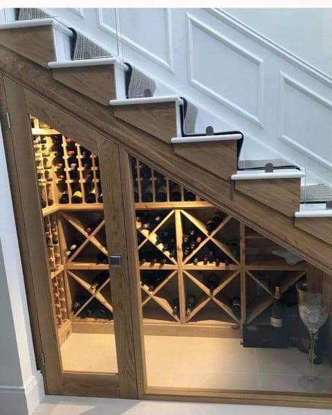 cool wood wine cellar under stairs