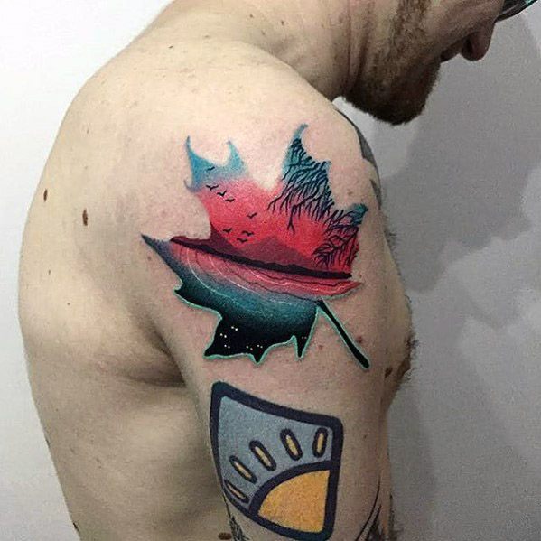 Colorful lake tattoo shaped like a maple leaf, with a vivid red sunset, mountain outlines, and birds flying over still water.