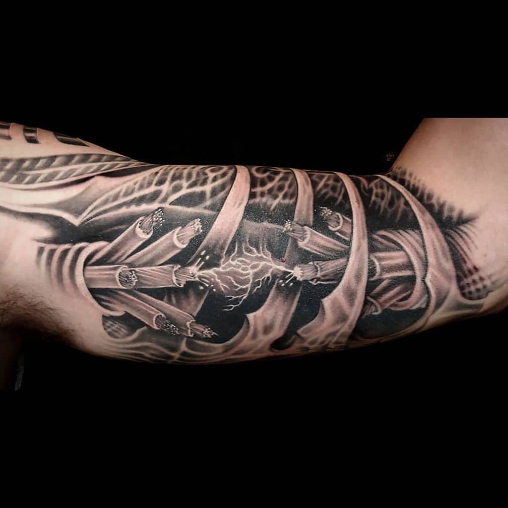 A detailed tattoo of exposed ribs and tendons on an arm creates a realistic skeletal effect