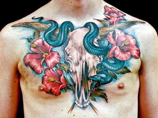 Colorful chest tattoo of a skull, green snake, and red flowers