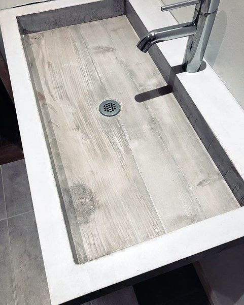 Modern bathroom with large mirror, vessel sink, and minimalist pendant lights