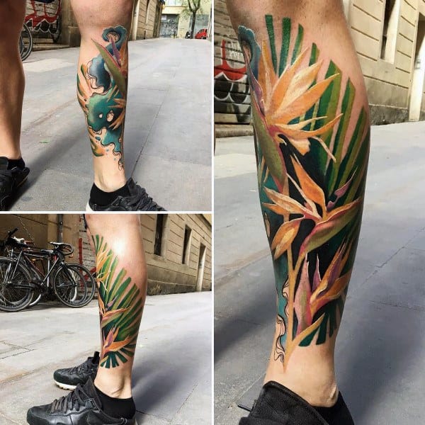 Vibrant leg tattoo featuring tropical leaves and bird of paradise flowers, symbolizing exotic beauty, freedom, and a love for nature.