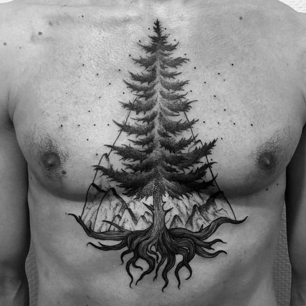 Black and grey chest tattoo of a tall pine tree with deep roots, set against a mountain landscape and a starry sky, symbolizing resilience and nature.