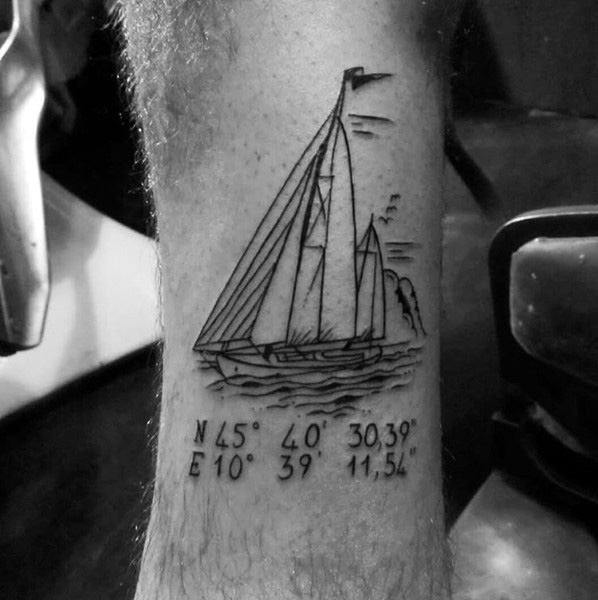 Sailboat coordinate tattoo on the leg with fine black linework, symbolizing adventure, freedom, and a meaningful nautical location.
