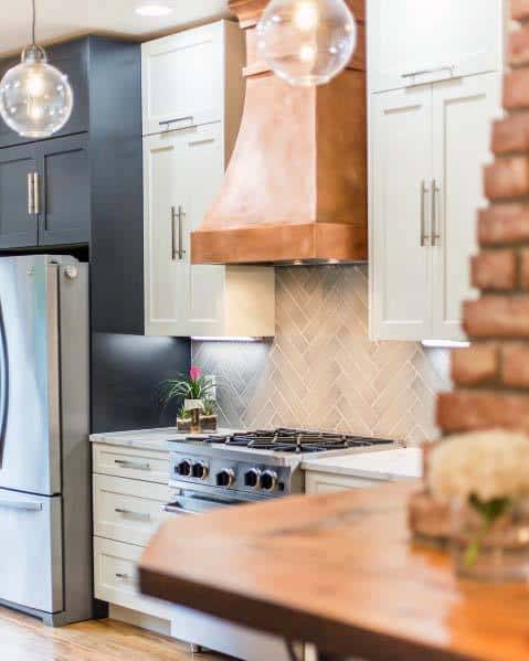rustic copper metal hood in white cabinet kitchen