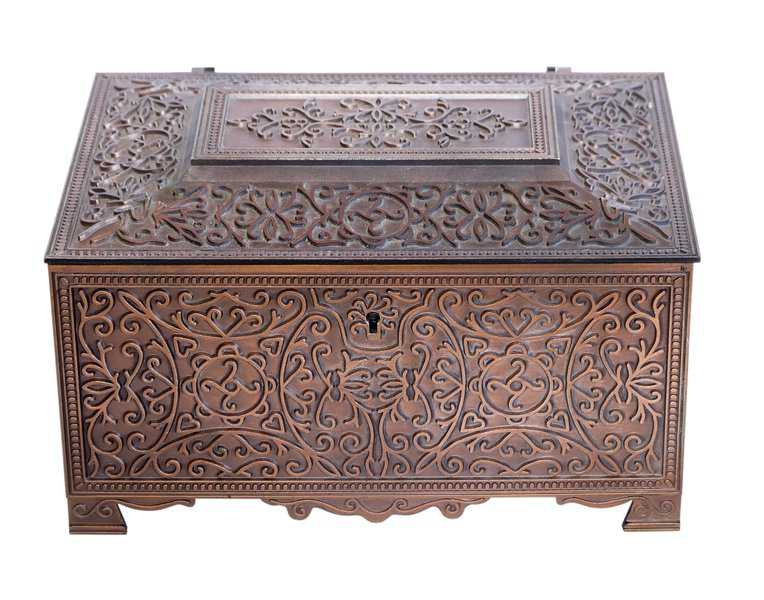 Ornate copper chest with intricate floral patterns and a small keyhole on the front.