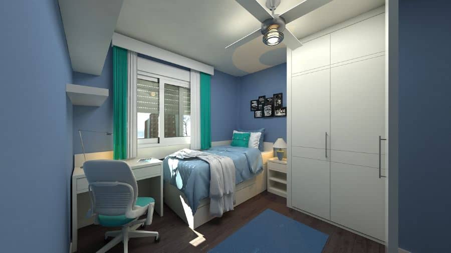 Boy's blue bedroom with white wardrobe, study desk, and ceiling fan.