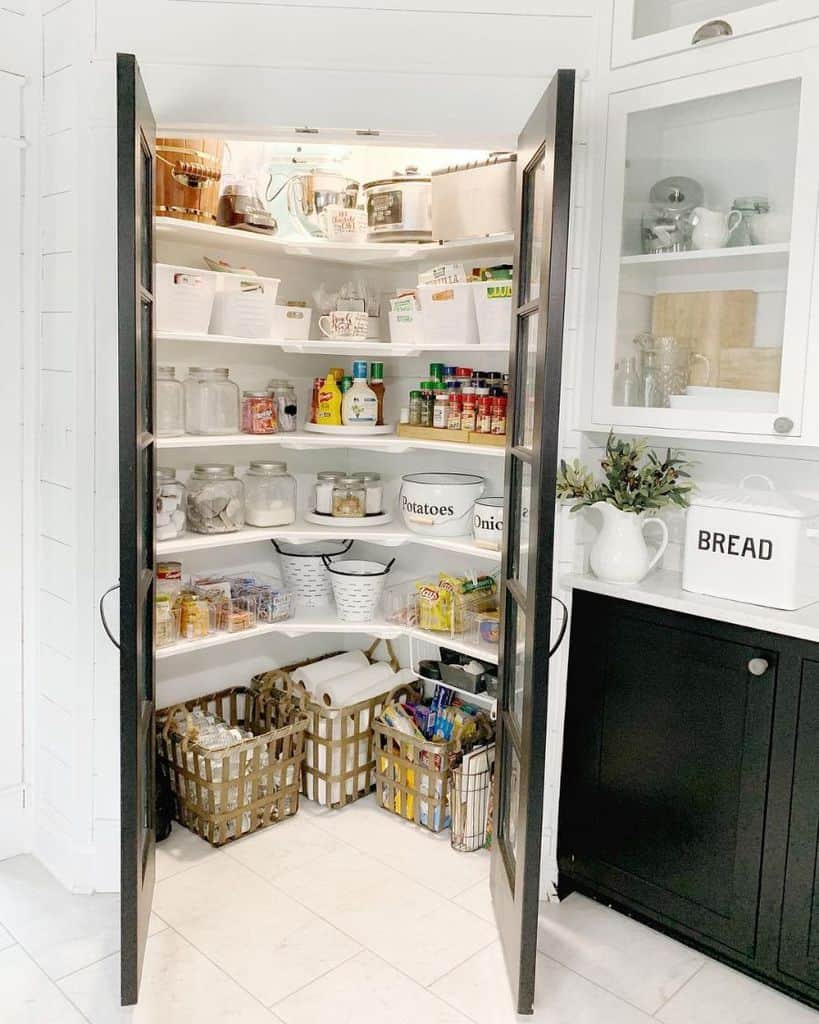 large corner pantry shelving with black window doors