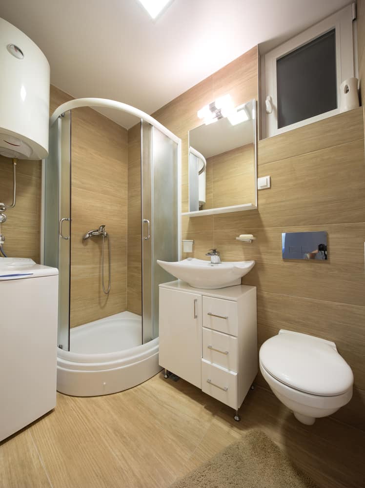 corner shower and floating toilet bathroom