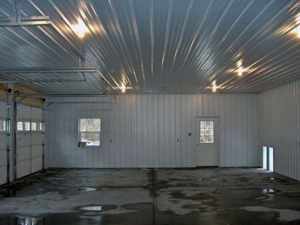 Garage with corrugated metal ceiling, bright lighting, and polished concrete flooring.