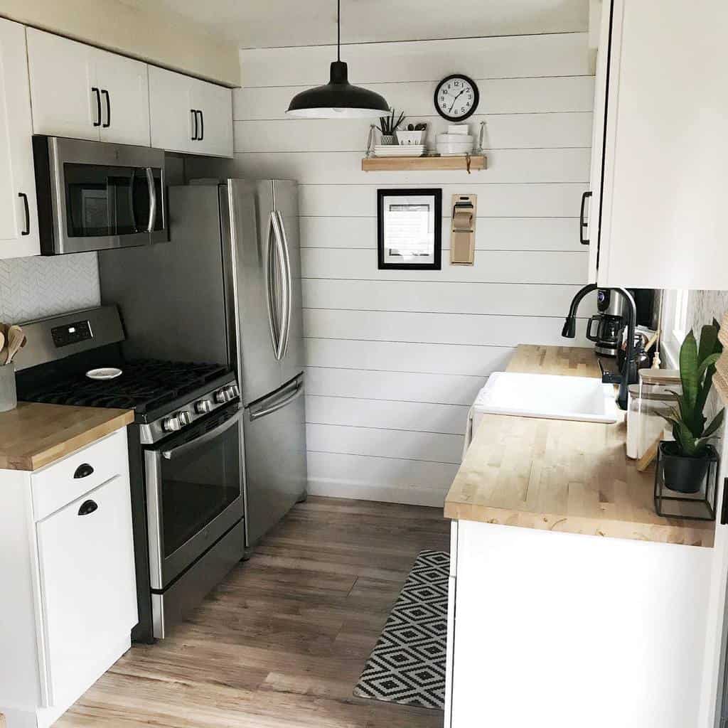 small cottage galley kitchen shiplap walls wood bench tops