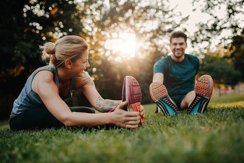 couple doing exercise while staring at each other