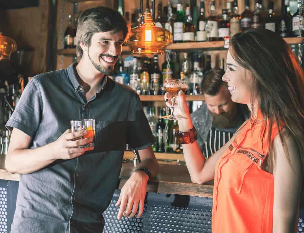 couple drinking cocktail at the bar
